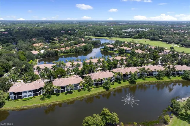 an aerial view of residential houses with outdoor space and lake view
