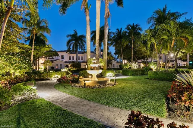 a dining room with lots of furniture and chandelier