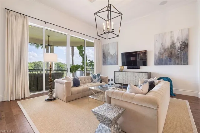 a living room with furniture a flat screen tv and a large window