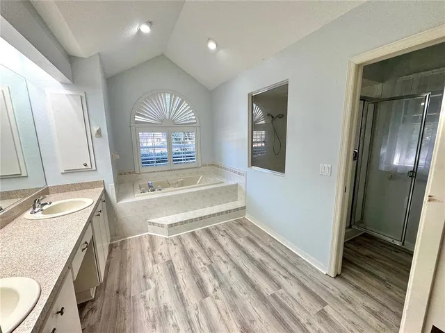 a spacious bathroom with a sink and a mirror
