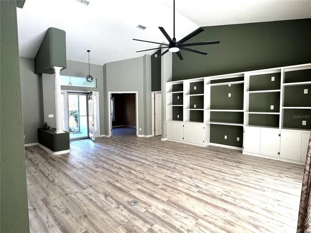 a view of a living room with furniture and a fireplace