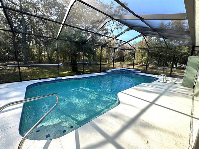 a view of a swimming pool with a patio