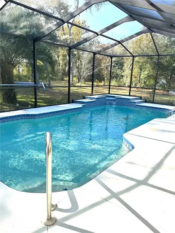 a view of a swimming pool with a yard