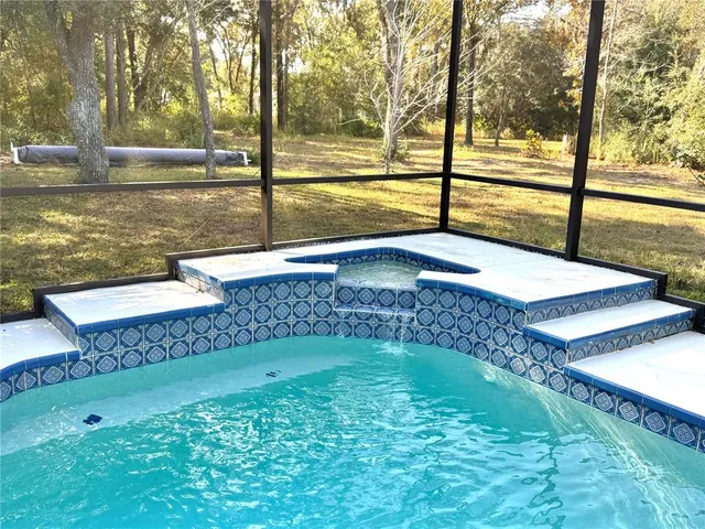 a view of a swimming pool with a patio