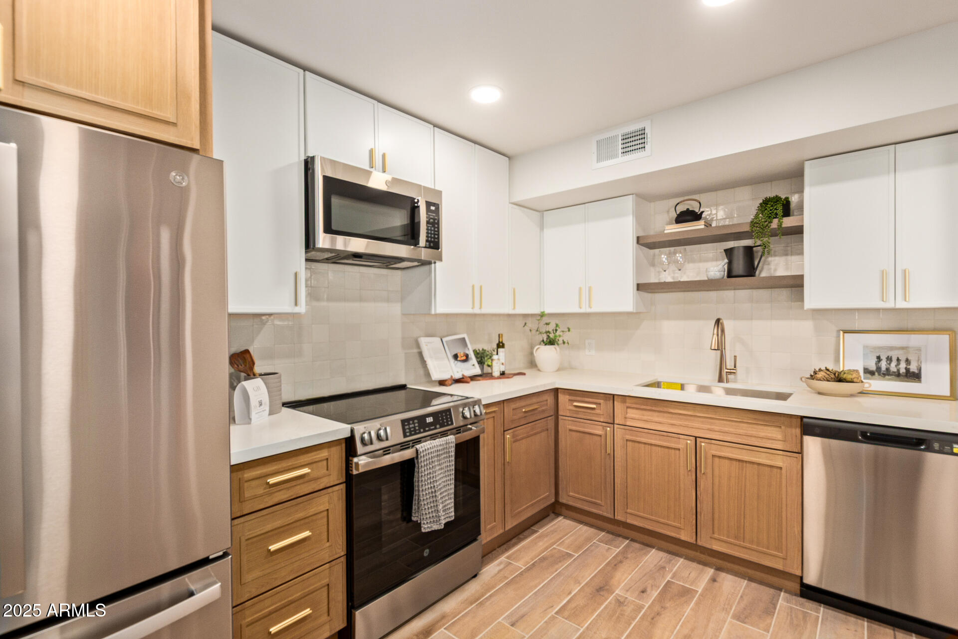 4201 East Camelback Road, Unit 28 Phoenix, AZ 85018 - Photo 1 of 15 a kitchen with a sink stove cabinets and refrigerator