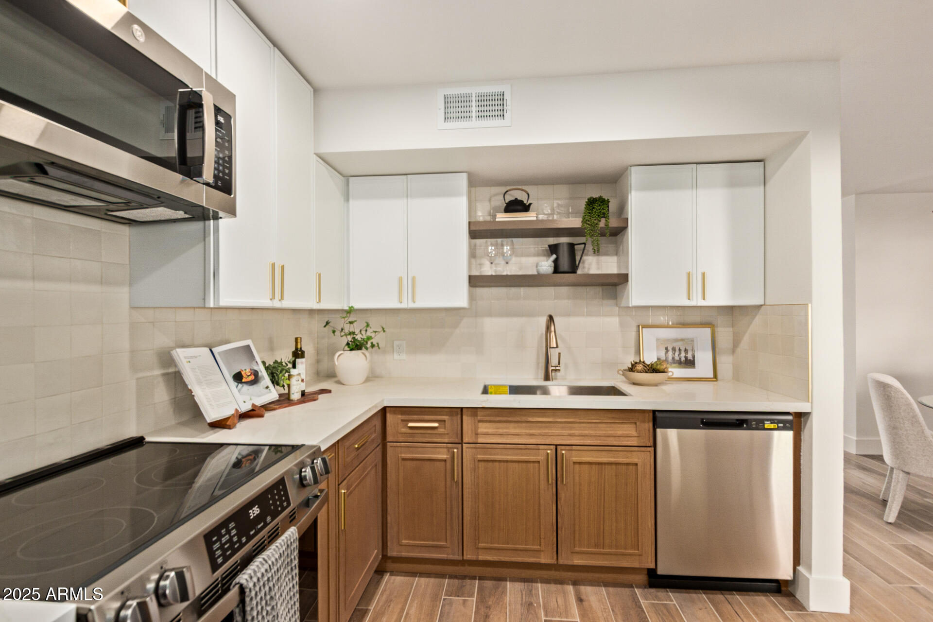 4201 East Camelback Road, Unit 28 Phoenix, AZ 85018 - Photo 11 of 15 a kitchen with stainless steel appliances a sink stove and cabinets