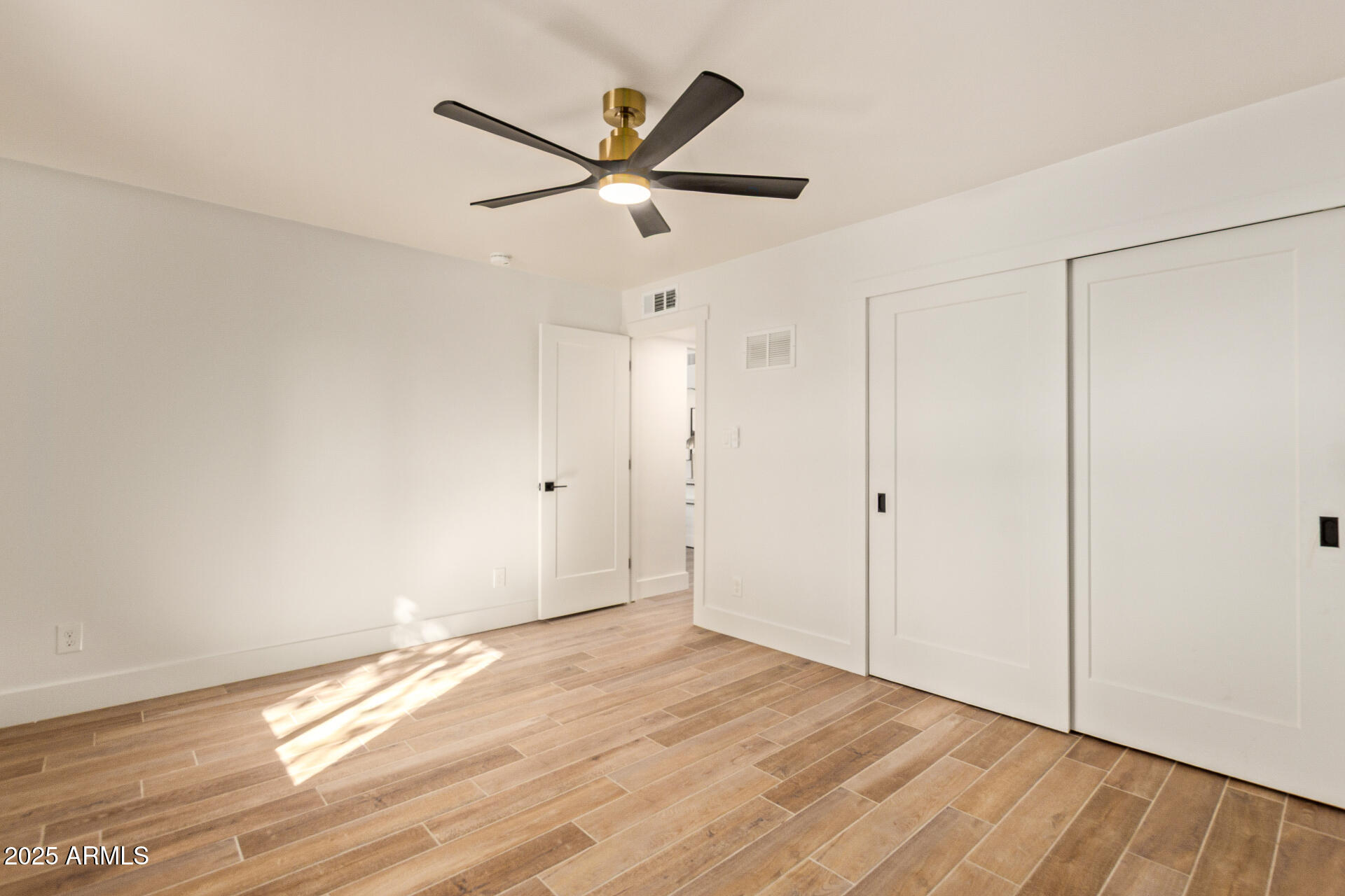 4201 East Camelback Road, Unit 28 Phoenix, AZ 85018 - Photo 12 of 15 a view of a big room with wooden floor closet and windows