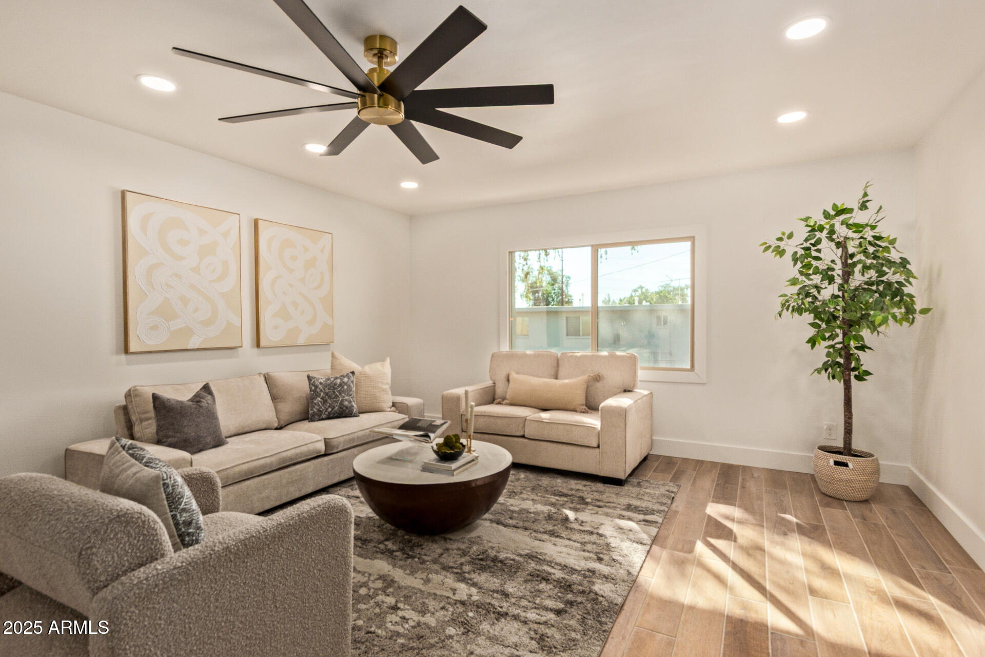 4201 East Camelback Road, Unit 28 Phoenix, AZ 85018 - Photo 5 of 15 a living room with furniture a chandelier and a window
