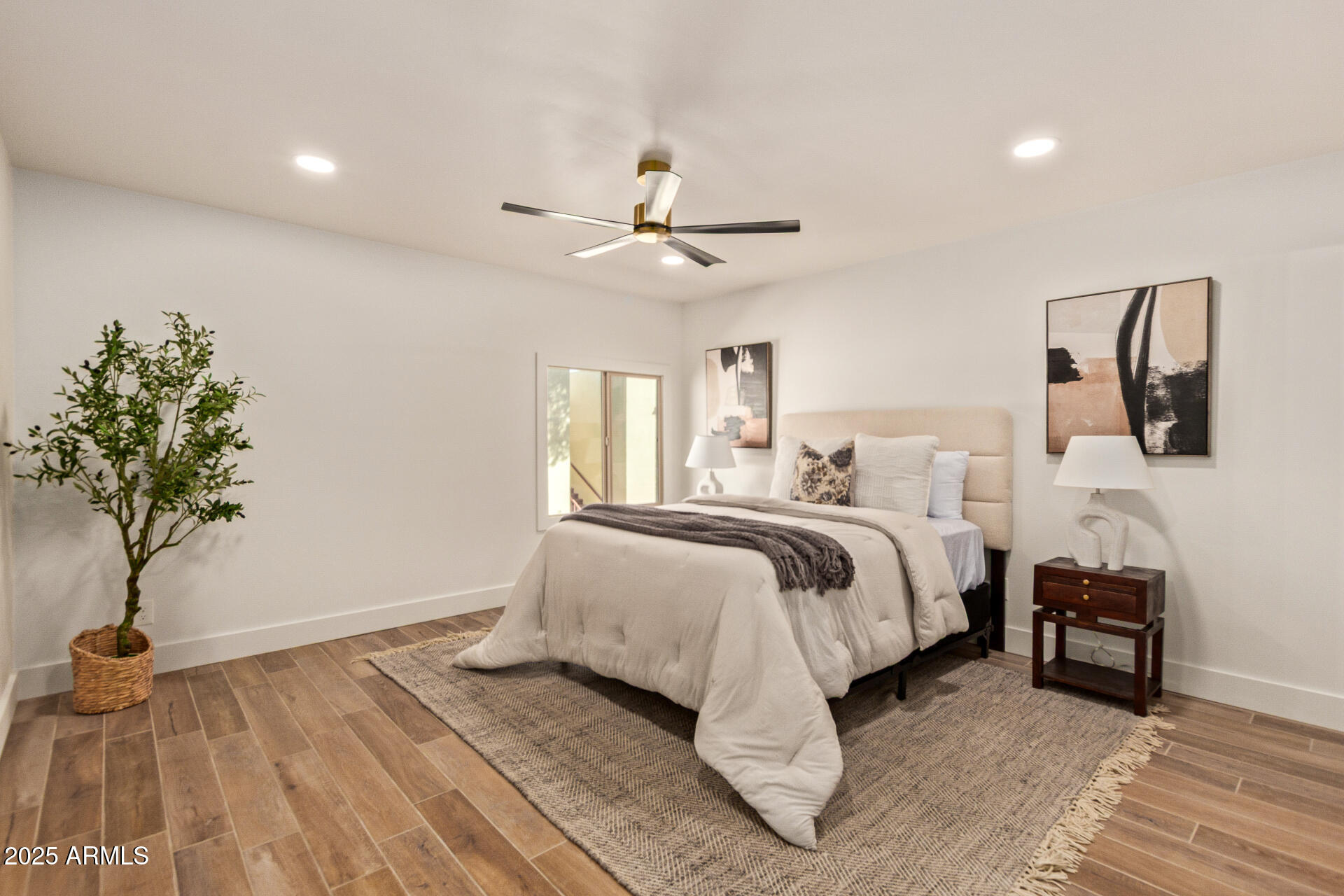 4201 East Camelback Road, Unit 28 Phoenix, AZ 85018 - Photo 6 of 15 a spacious bedroom with a bed and a potted plant