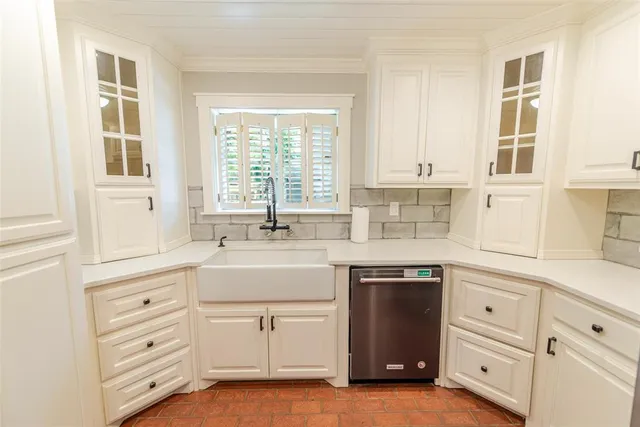 a kitchen with cabinets appliances and a window