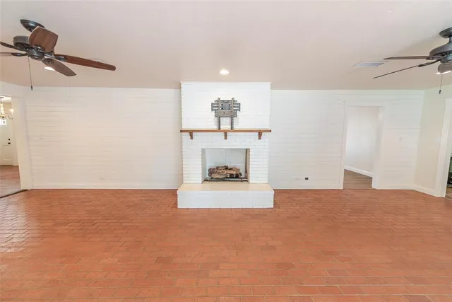 a view of empty room with a fireplace