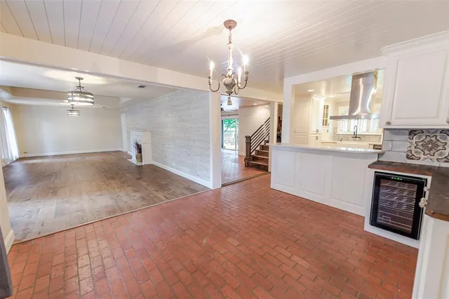 a view of a kitchen with a sink and a chandelier