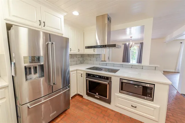 a kitchen with stainless steel appliances a refrigerator sink and stove