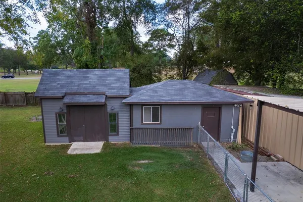 a view of backyard of house with green space