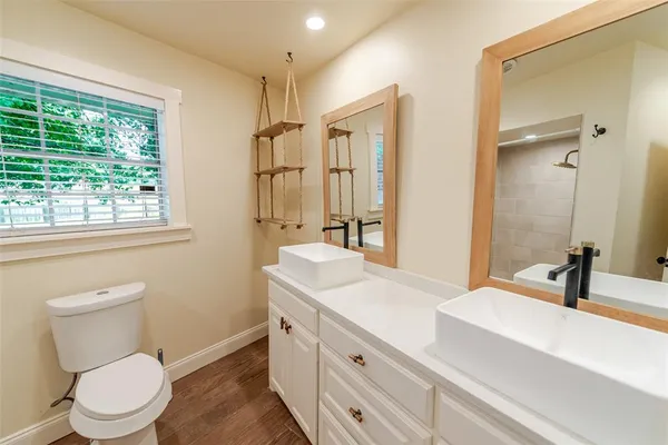 a bathroom with a sink a toilet and shower