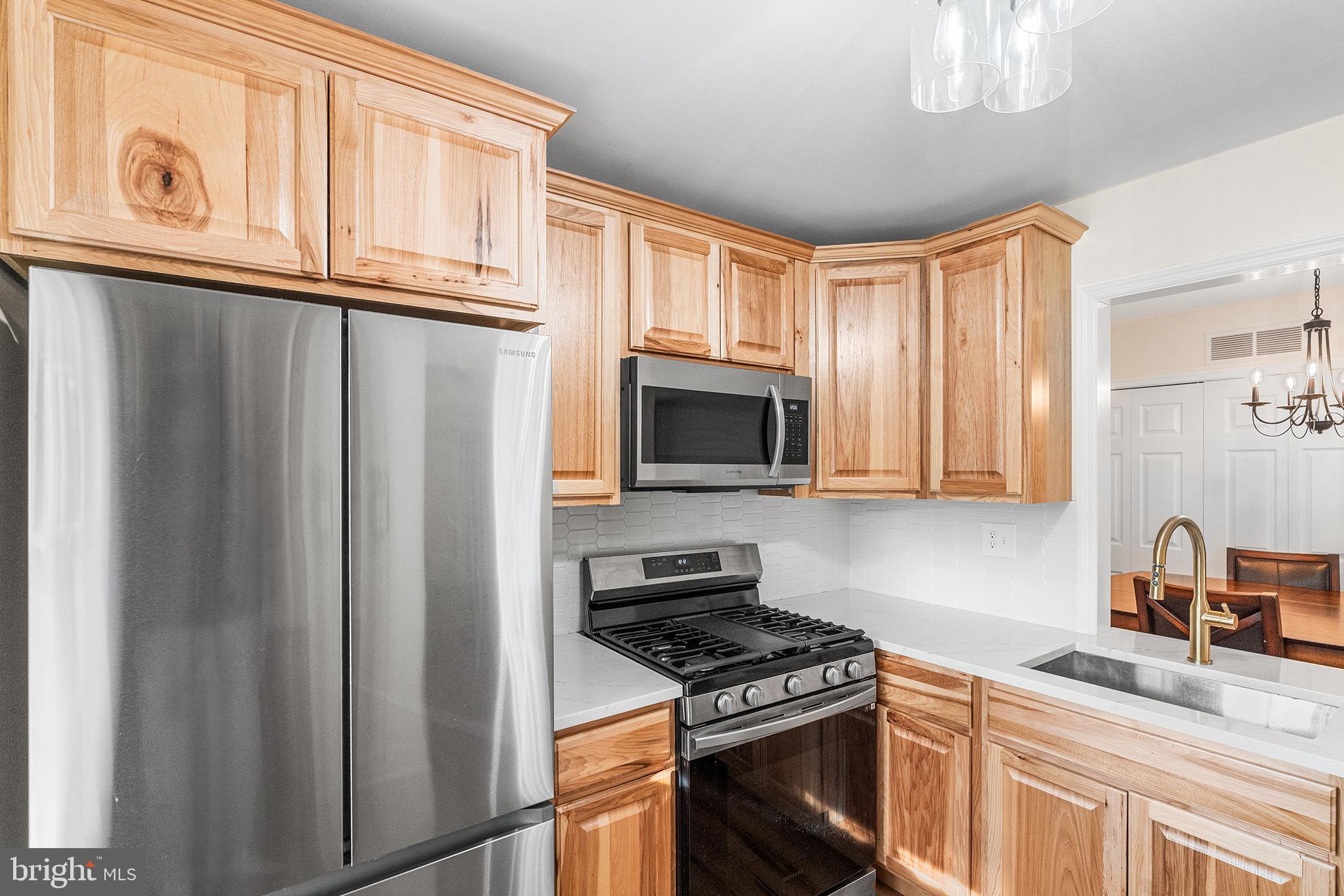 205 Boothby Court Sewell, NJ 08080 - Photo 12 of 21 a kitchen with stainless steel appliances granite countertop a refrigerator stove top oven a sink and dishwasher