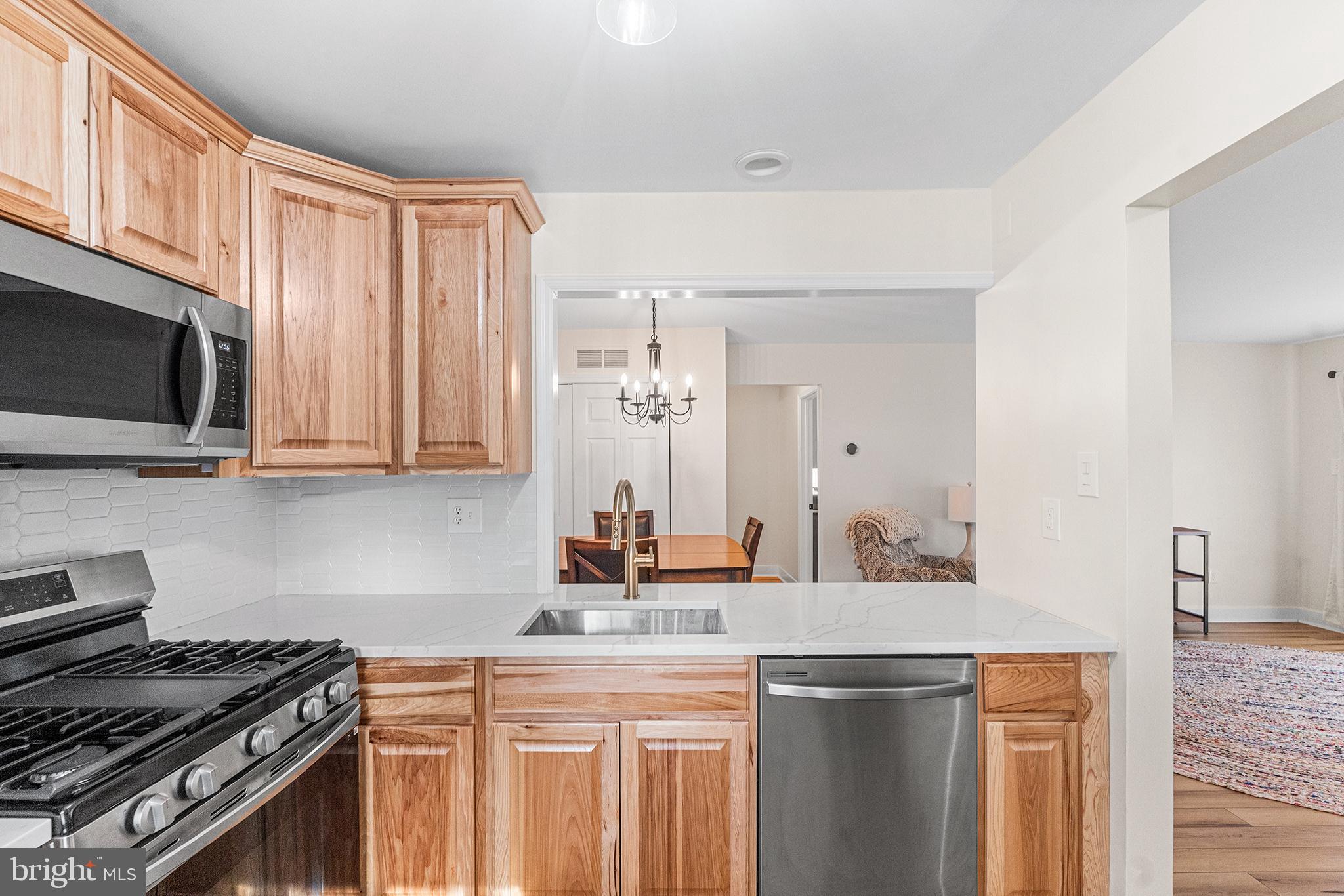 205 Boothby Court Sewell, NJ 08080 - Photo 13 of 21 a kitchen with stainless steel appliances granite countertop a stove and a sink