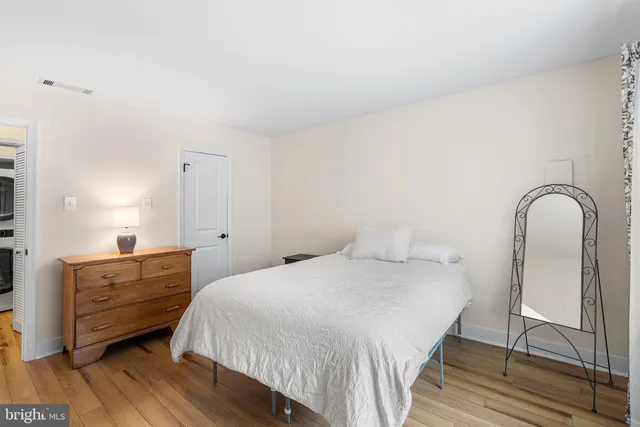 a bedroom with a bed and a dresser