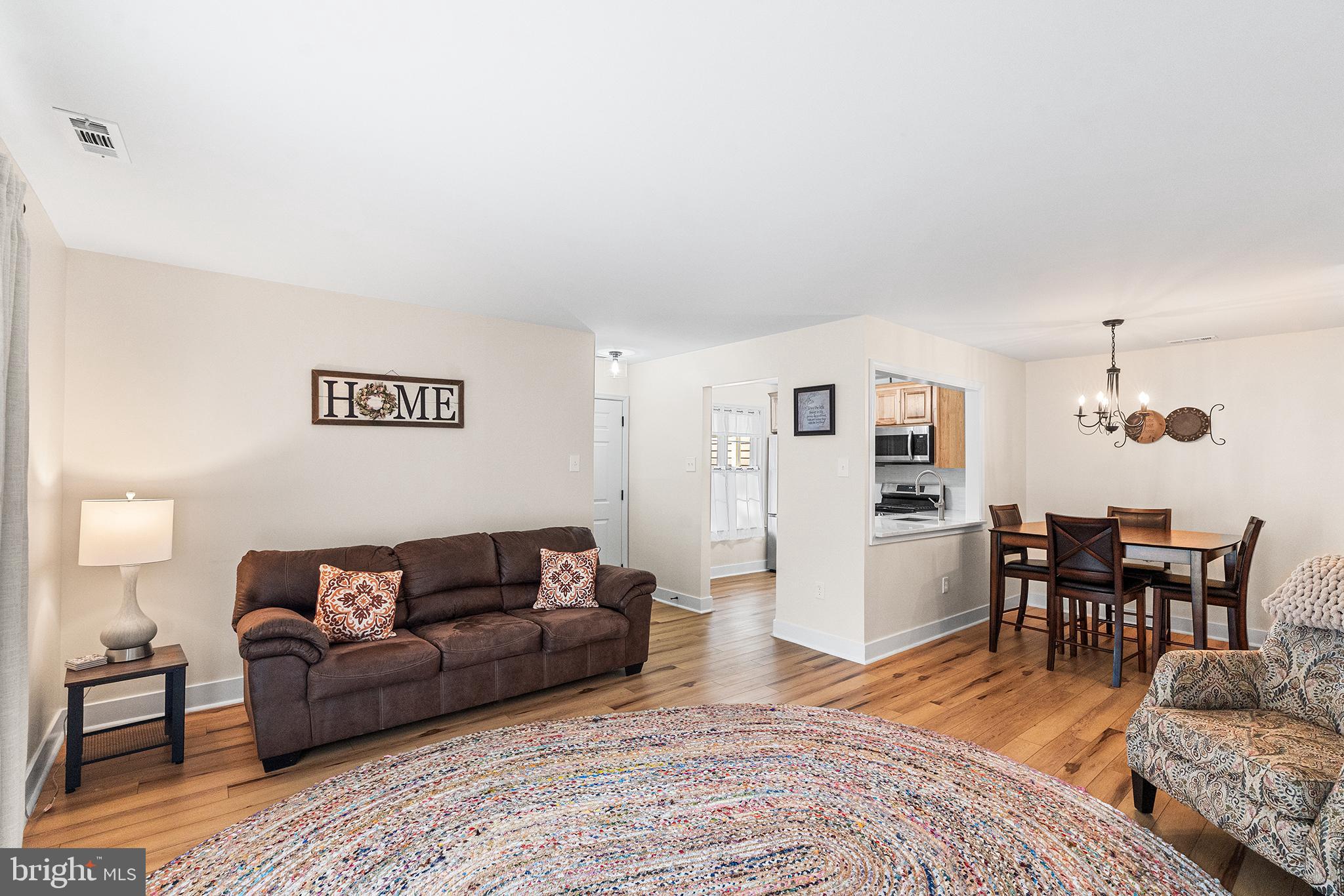 205 Boothby Court Sewell, NJ 08080 - Photo 6 of 21 a living room with furniture and a dining table with wooden floor