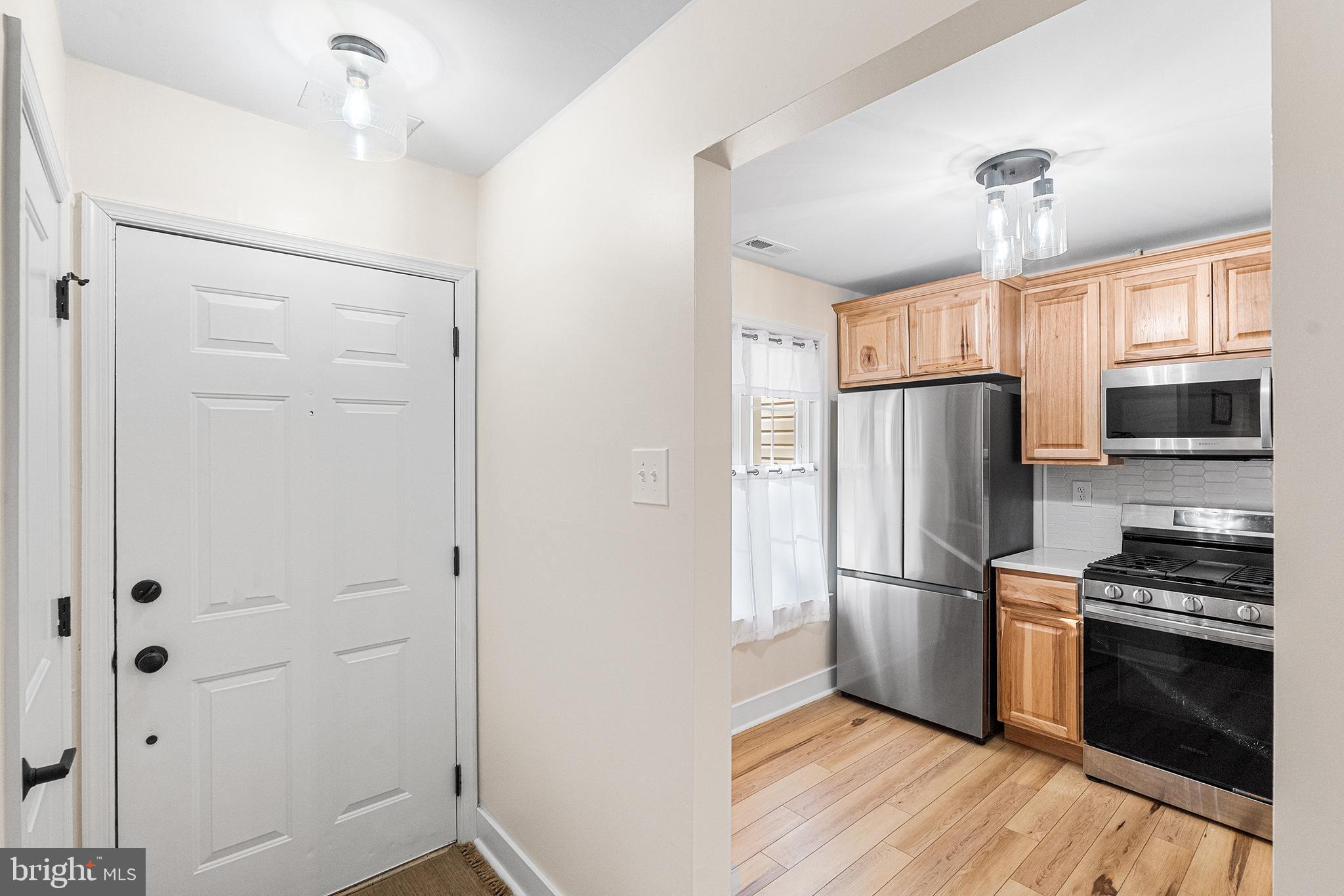 205 Boothby Court Sewell, NJ 08080 - Photo 10 of 21 a kitchen with cabinets stainless steel appliances and wooden floor