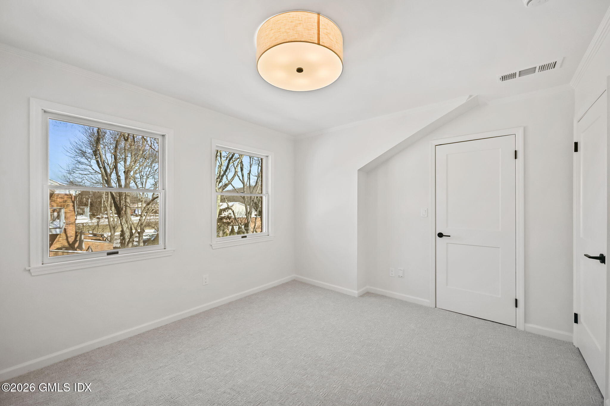 115 River Road, Unit 7 Cos Cob, CT 06807 - Photo 12 of 17 a view of an empty room with window and wooden floor