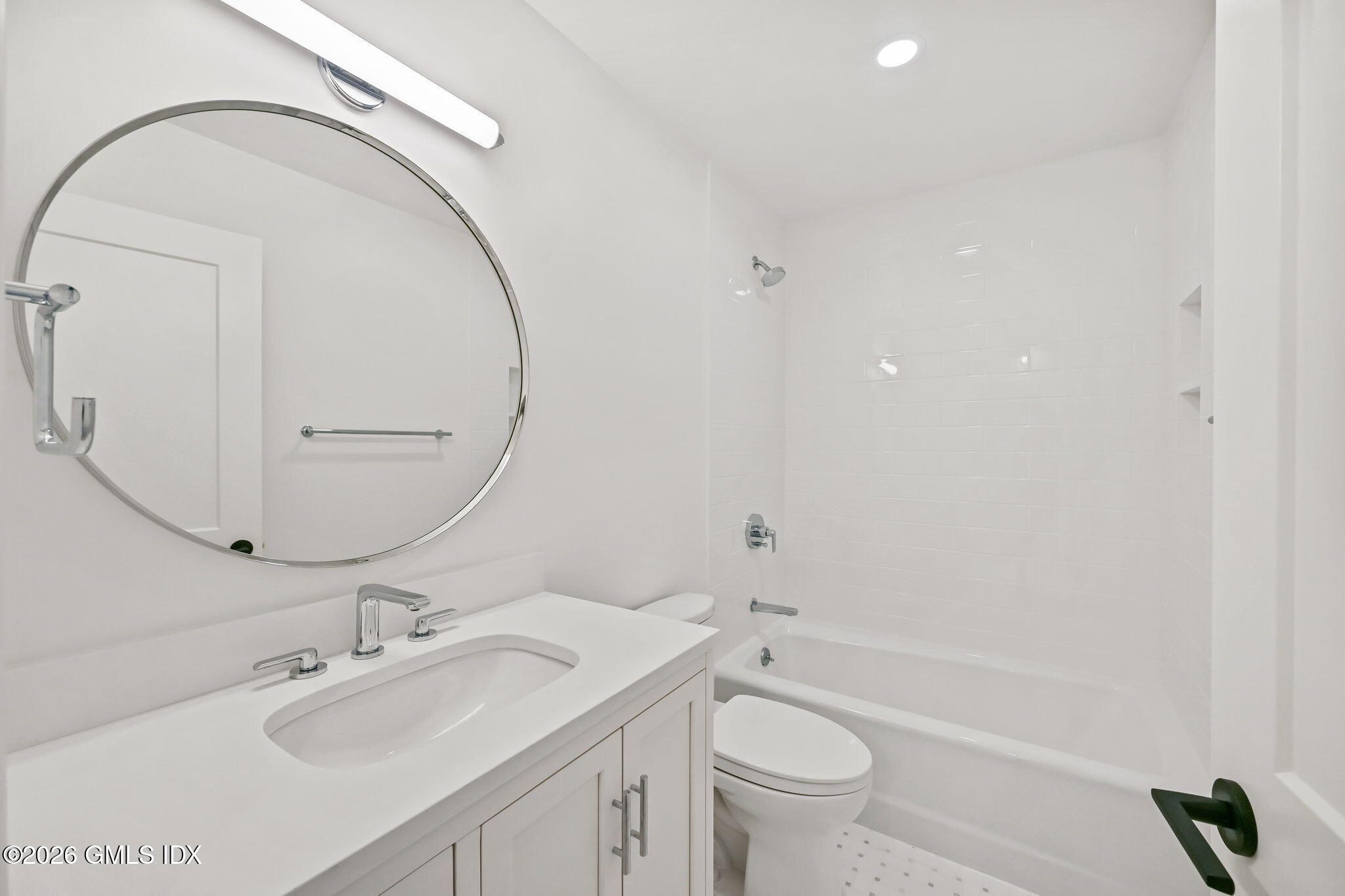 115 River Road, Unit 7 Cos Cob, CT 06807 - Photo 13 of 17 a bathroom with a sink a toilet and a mirror
