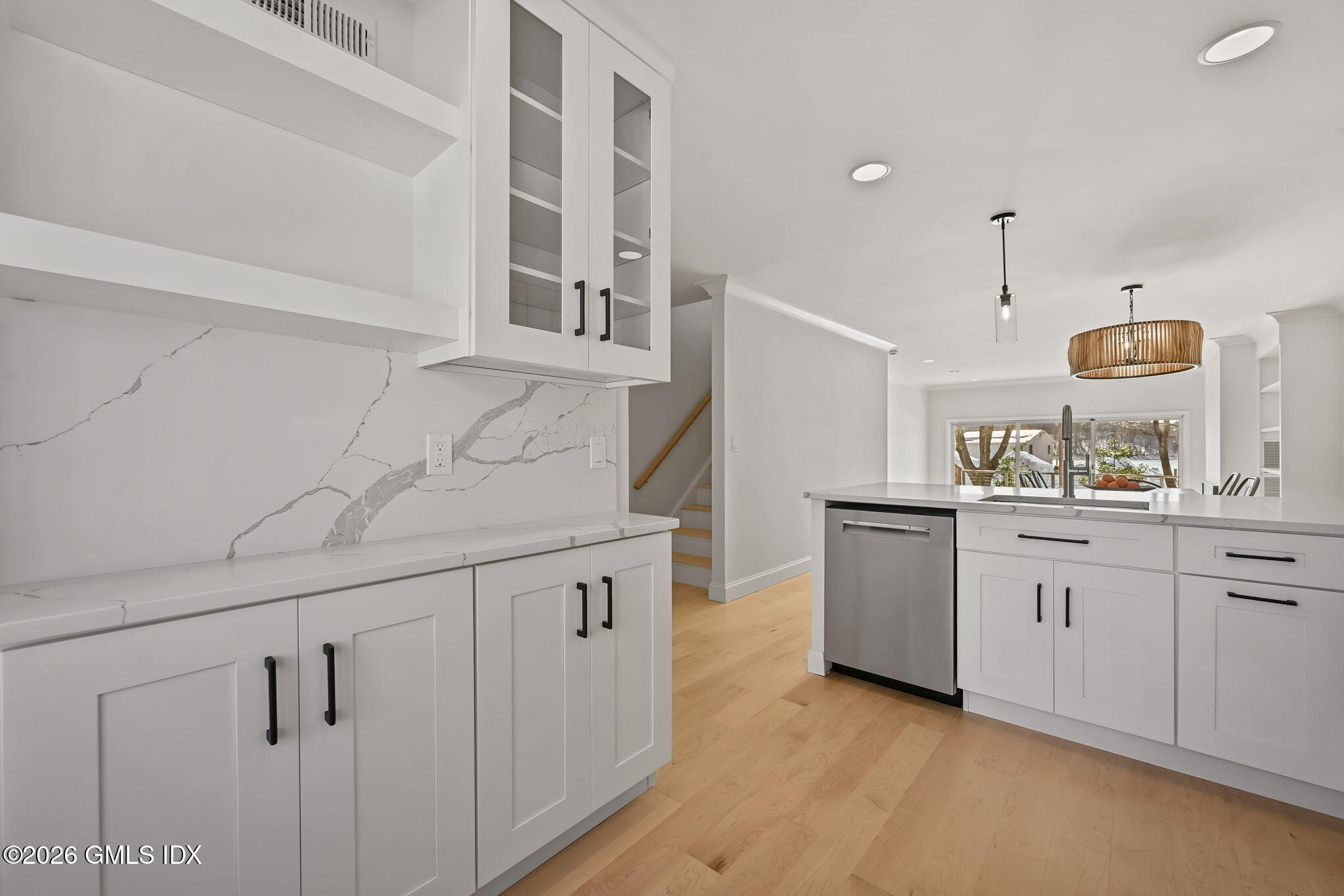 115 River Road, Unit 7 Cos Cob, CT 06807 - Photo 8 of 17 a kitchen with white cabinets and sink