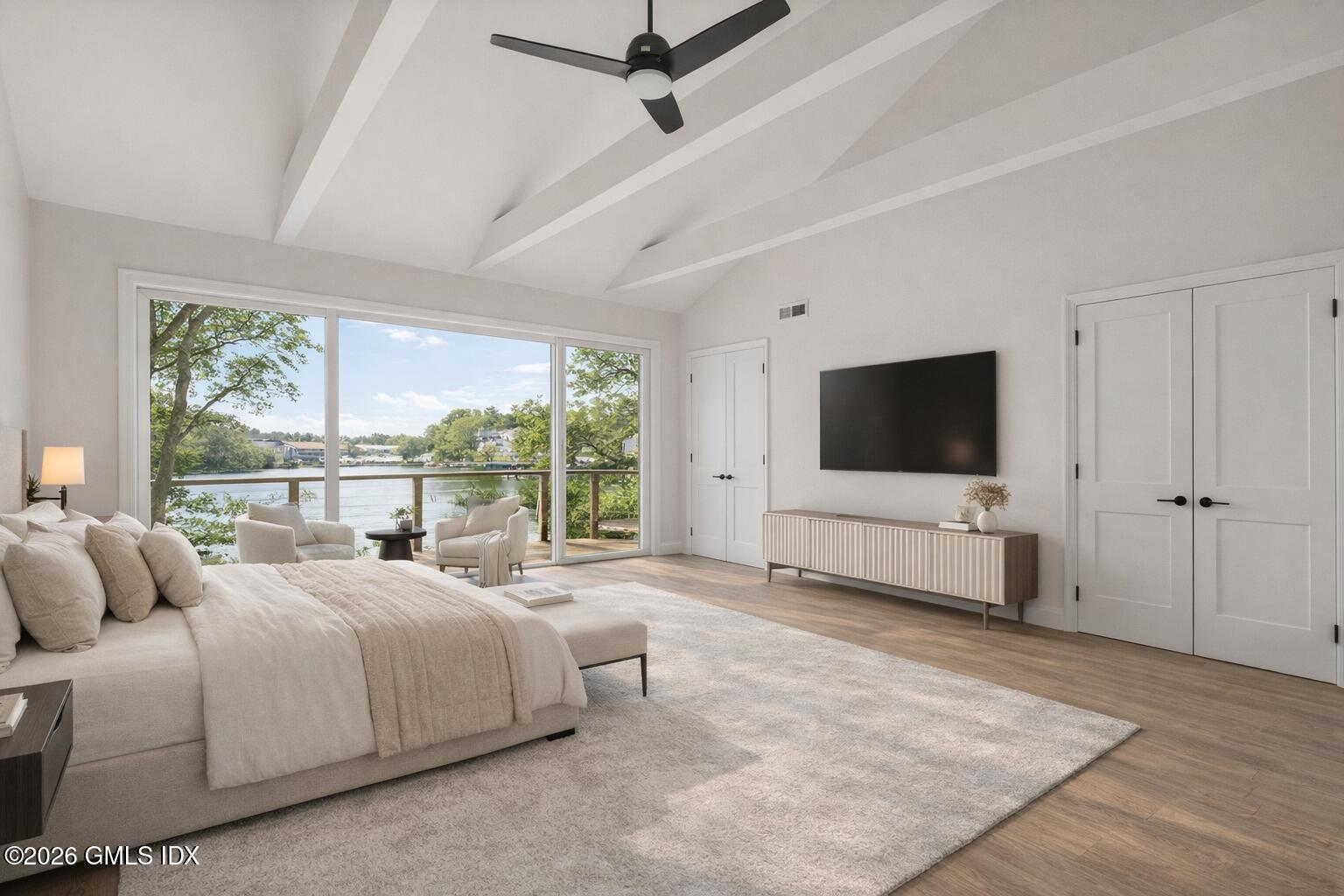 115 River Road, Unit 7 Cos Cob, CT 06807 - Photo 10 of 17 a bedroom with a bed and a flat screen tv