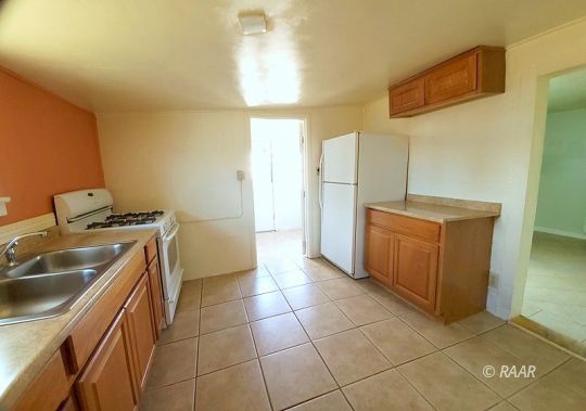 212 West Robertson Road Ridgecrest, CA 93555 - Photo 3 of 18 a kitchen with a sink and cabinets