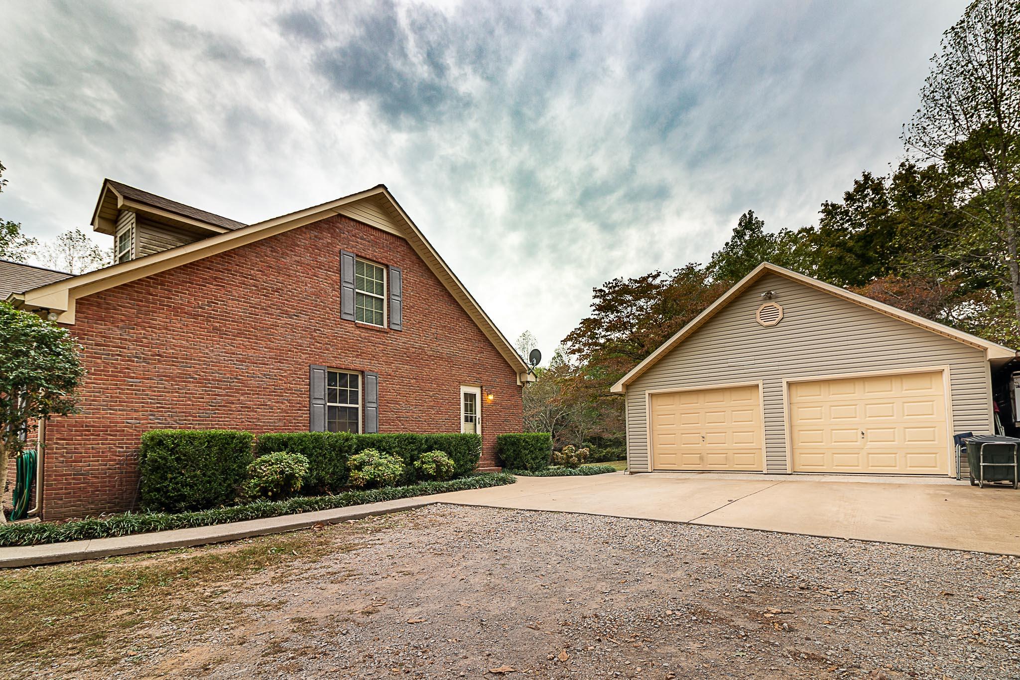 611 Sumac Road Pulaski, TN 38478 - Photo 22 of 30 a front view of a house with a yard and garage