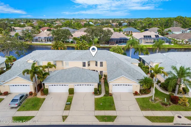 a large white kitchen with stainless steel appliances a stove a sink a refrigerator and white cabinets