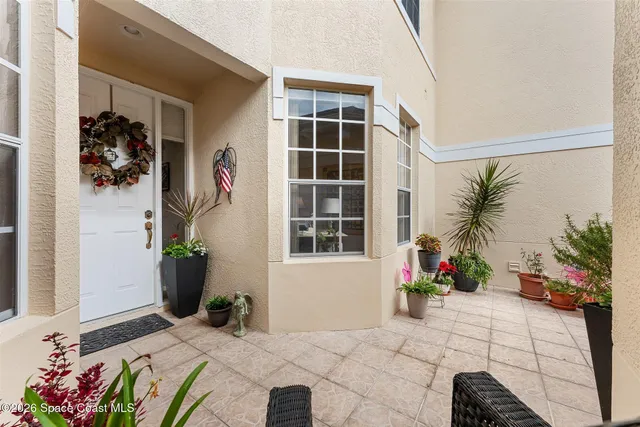 a bedroom with bed and a large window