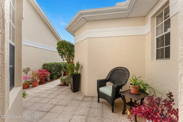 a bedroom with three beds and a chandelier