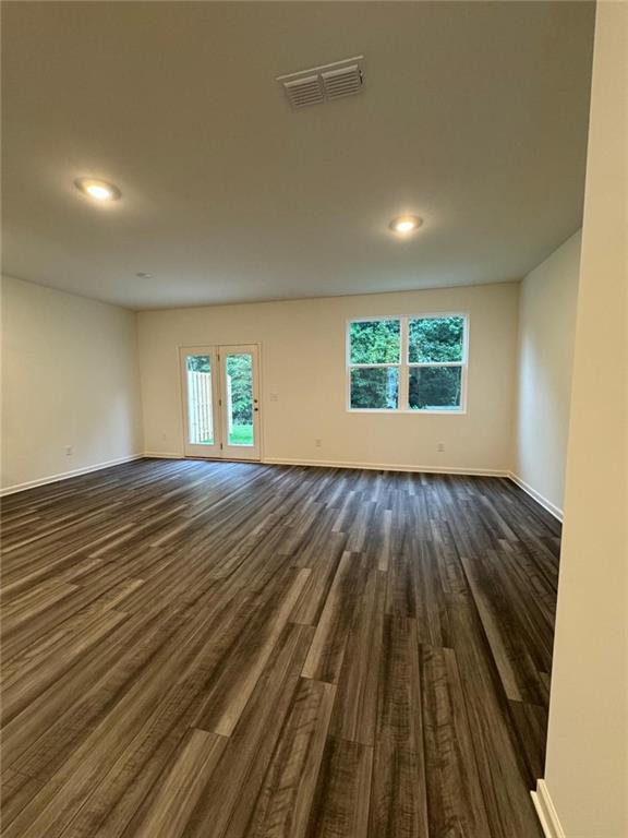 87 Ingleton Drive, Unit 87 Winder, GA 30680 - Photo 3 of 12 an empty room with wooden floor and windows