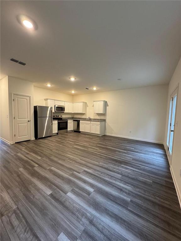 87 Ingleton Drive, Unit 87 Winder, GA 30680 - Photo 4 of 12 a view of a room with wooden floor and furniture