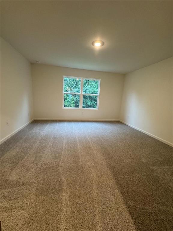 87 Ingleton Drive, Unit 87 Winder, GA 30680 - Photo 8 of 12 an empty room with windows