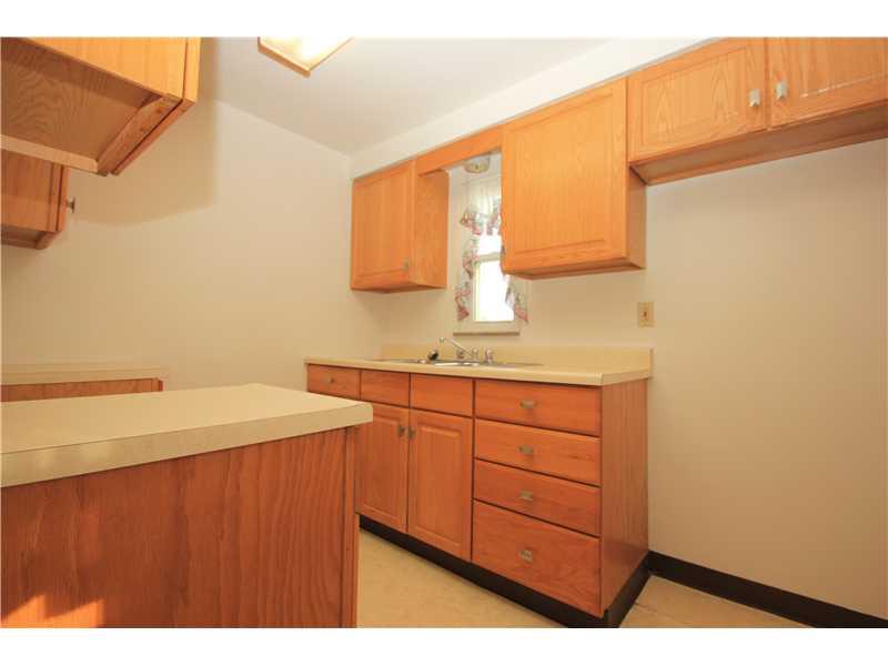 3428 Willett Road Baldwin, PA 15227 - Photo 4 of 17 Kitchen. Galley kitchen has nice wood cabinets and a vinyl floor. The window provides a view of the tabletop rear yard! No appliances included in the sale - could negotiate a credit for appliances if needed.