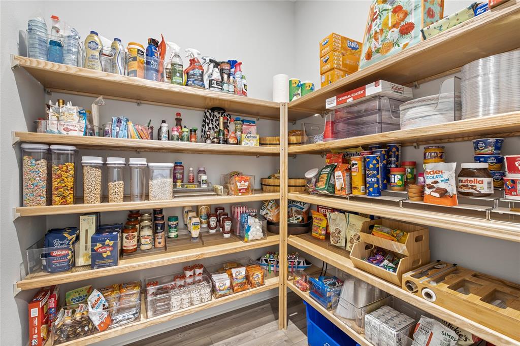 7445 Estuary Lk Loop Kissimmee, FL 34747 - Photo 12 of 54 a cabinet in a kitchen with lots of different kinds of food