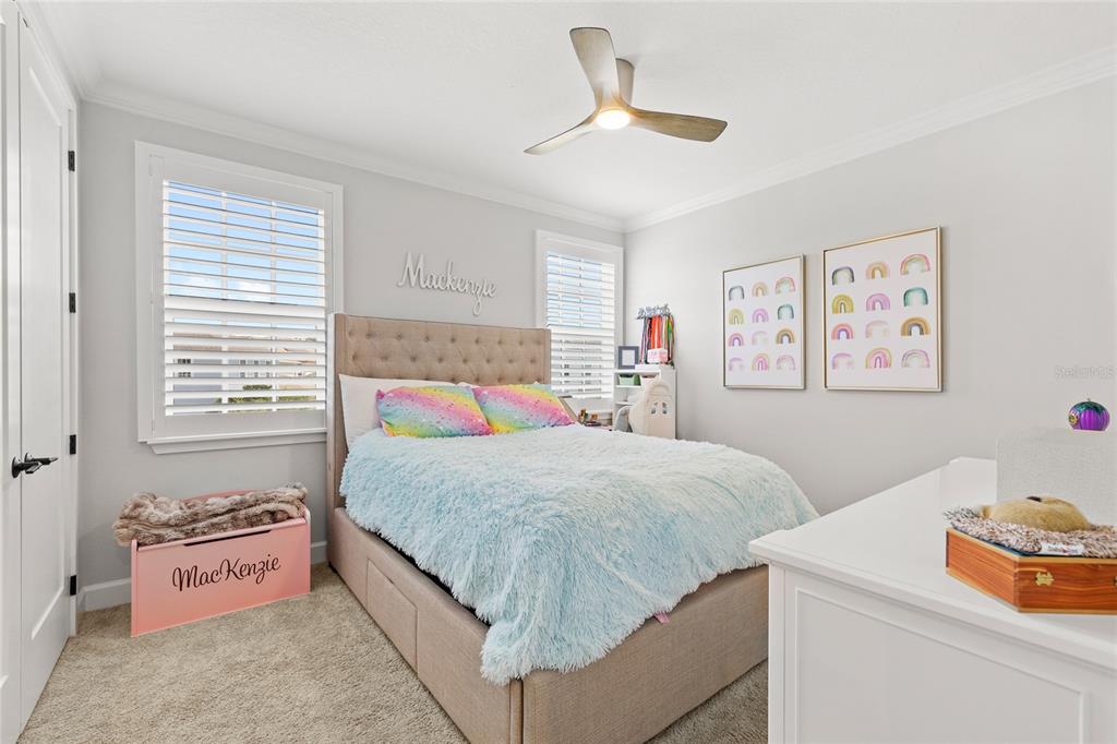 7445 Estuary Lk Loop Kissimmee, FL 34747 - Photo 25 of 54 a bedroom with a bed and a chandelier