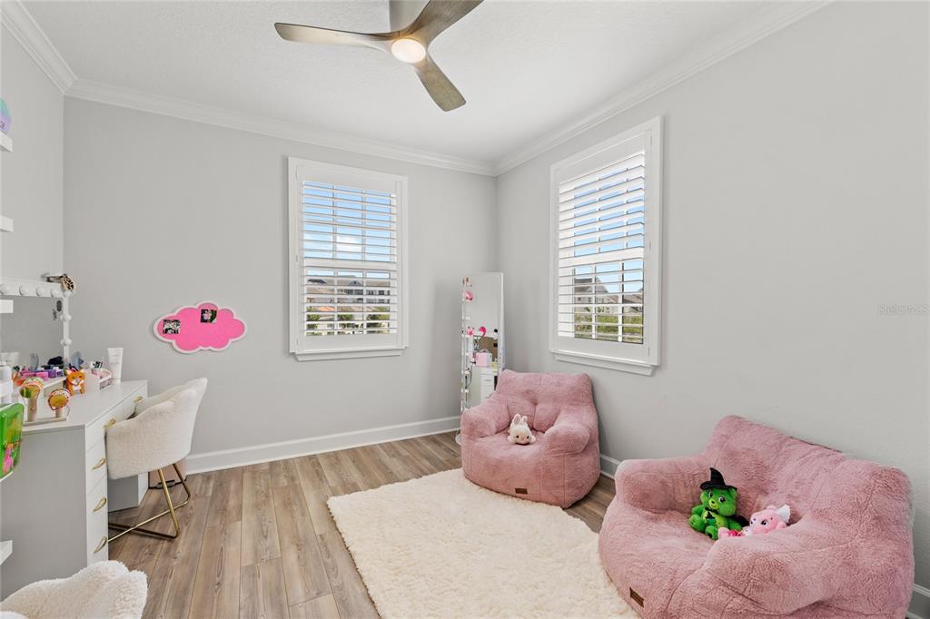 7445 Estuary Lk Loop Kissimmee, FL 34747 - Photo 27 of 54 a bedroom with a bed and wooden floor