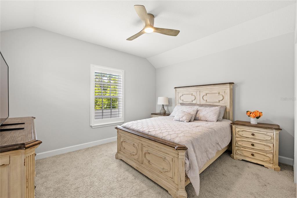 7445 Estuary Lk Loop Kissimmee, FL 34747 - Photo 40 of 54 a bedroom with a bed a chandelier and a window