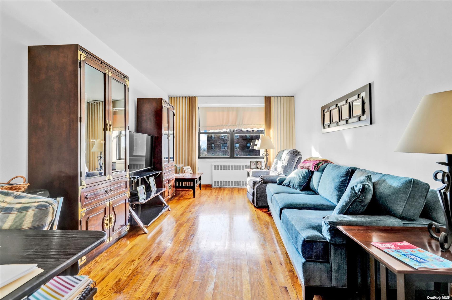 139-10 28th Road, Unit 4F Queens, NY 11354 - Photo 1 of 1 a living room with furniture and a flat screen tv