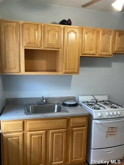 a kitchen with granite countertop wood cabinets and a sink