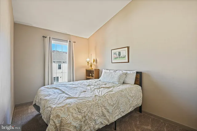 a bed sitting in a bedroom next to a bathroom