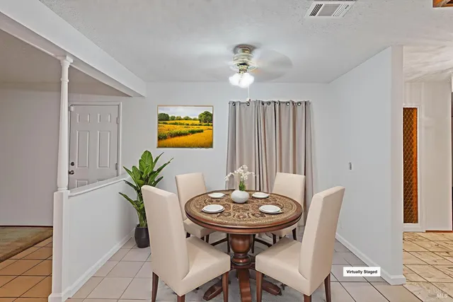 a view of a dining room with furniture and a potted plant