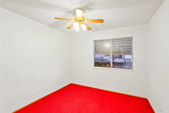 a view of a living room with a ceiling fan