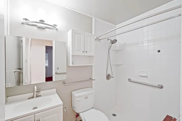 a bathroom with a sink toilet and shower