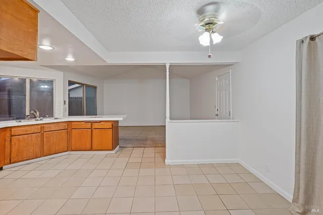 a spacious bathroom with a granite countertop sink a mirror and a bathtub