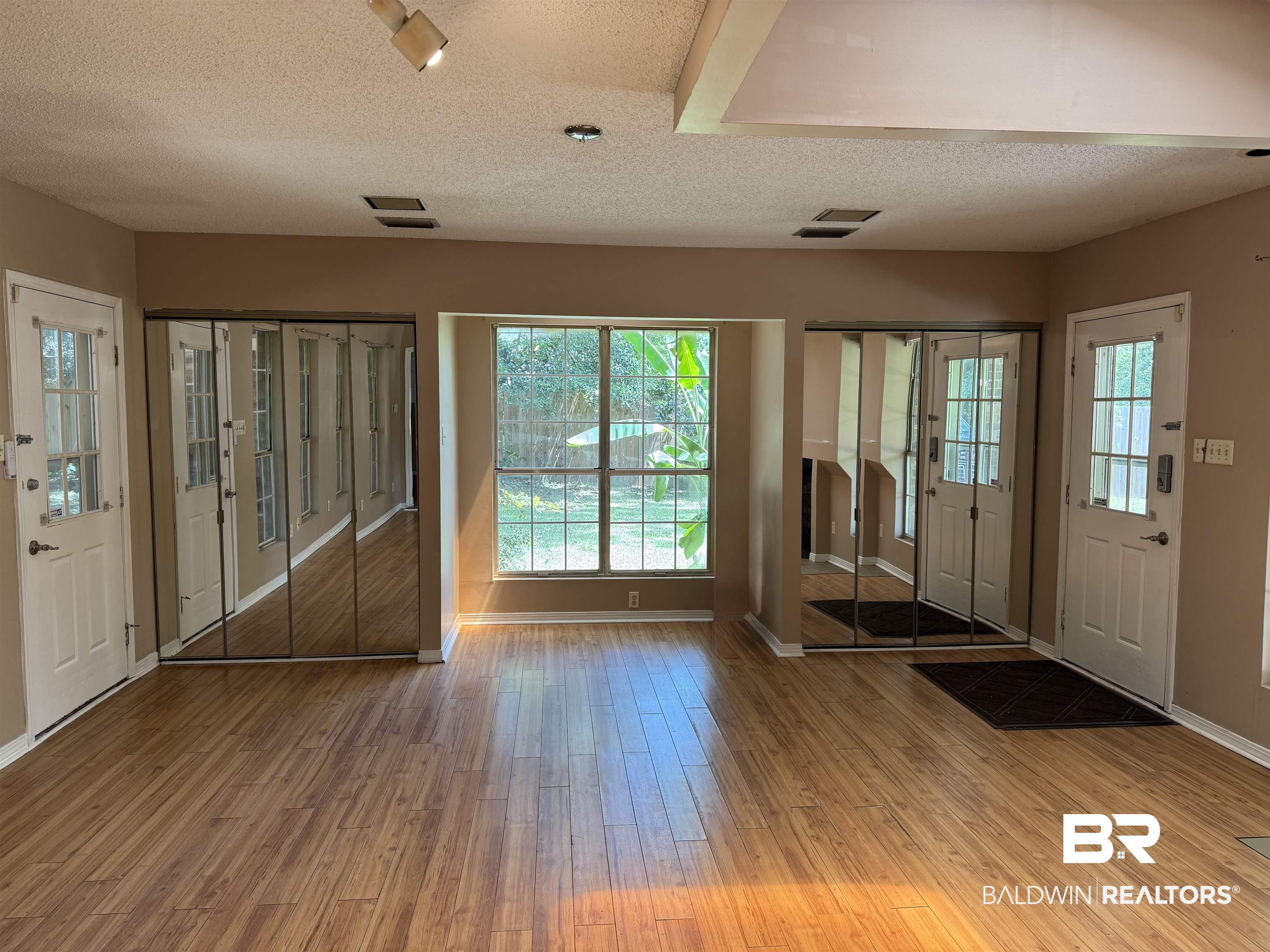 8070 Middle Ring Road Mobile, AL 36619 - Photo 12 of 26 Entrance foyer featuring wood finished floors, a textured ceiling, and plenty of natural light