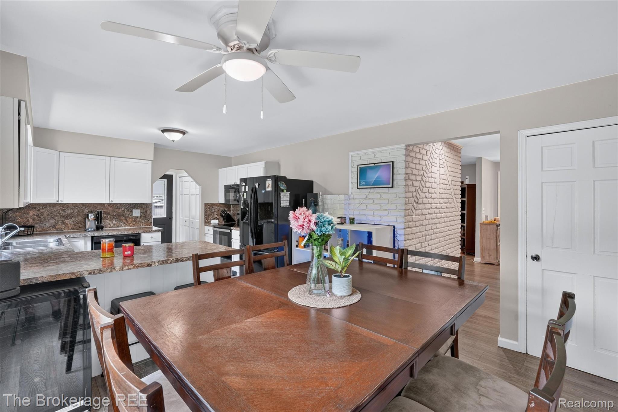 13269 North Genesee Road Clio, MI 48420 - Photo 16 of 67 Open-concept dining area featuring wood-finish flooring and a ceiling fan with integrated lighting